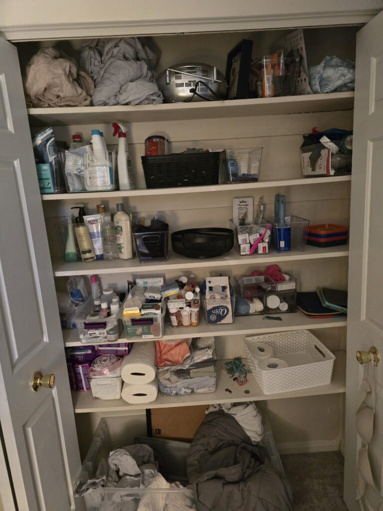 Closet shelves organized with clear bins